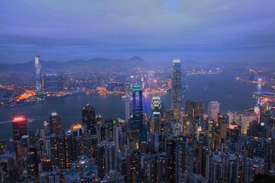 Illuminated cityscape against sky