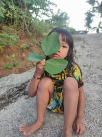 Full length of cute baby girl sitting on land