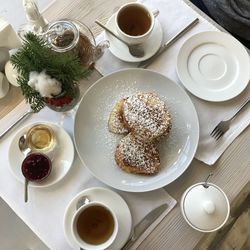 High angle view of coffee and cups on table