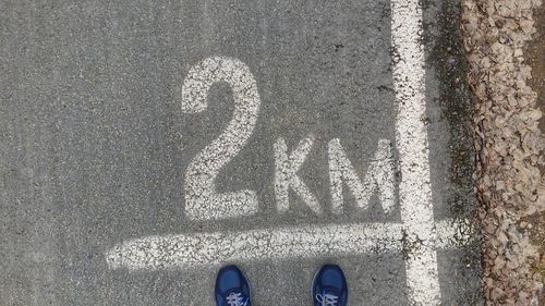 Low section of person standing on road