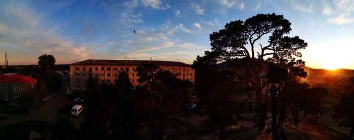 Panoramic shot of city against sky at sunset