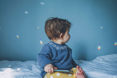 Cute baby girl on bed at home