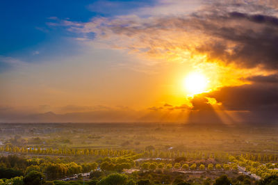 Scenic view of field against sky during sunset