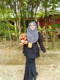 Woman standing on footpath