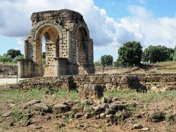 Old ruin on field against sky