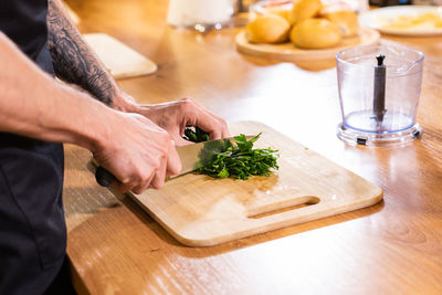 Midsection of man preparing food on table