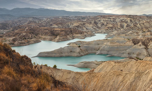 Scenic view of lake and mountains against sky