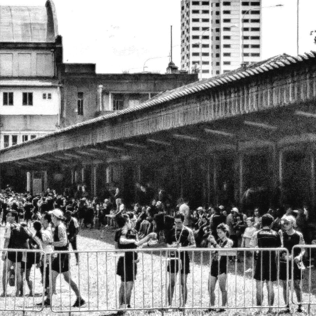 architecture, building exterior, built structure, fence, clear sky, day, railing, outdoors, wall - building feature, large group of people, building, in a row, steps, city, sky, residential building, protection, walking, brick wall