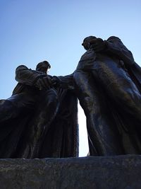 Low angle view of statue against clear blue sky