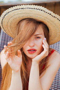 Portrait of young woman in hat