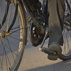 Low section of man with bicycle on street