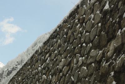 Low angle view of wall against sky