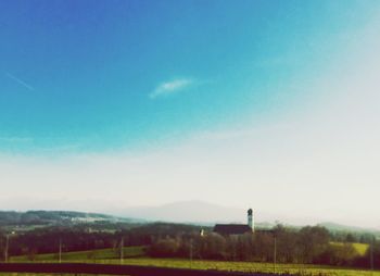 Scenic view of field against blue sky