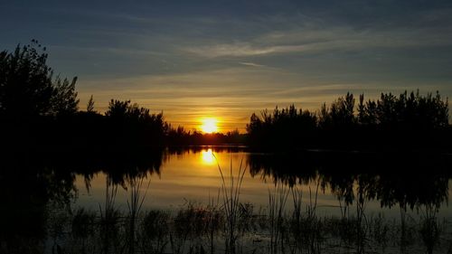 Scenic view of lake at sunset