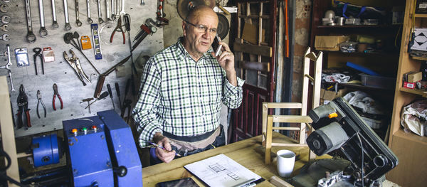 Midsection of man using mobile phone