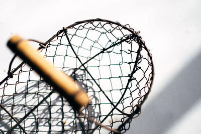 Close-up of crab pot against white wall