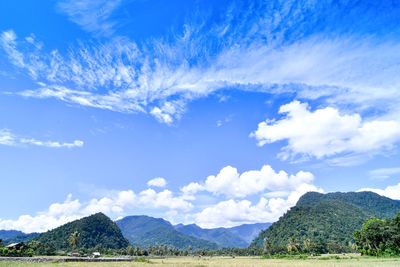 Scenic view of mountains against blue sky