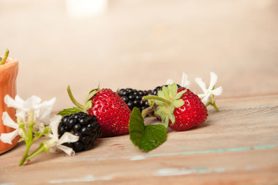 Close-up of strawberries and blackberries on wooden table