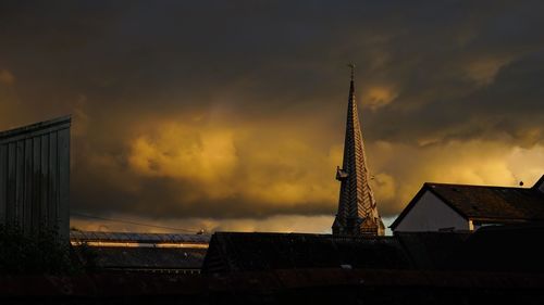 Low angle view of building against cloudy sky