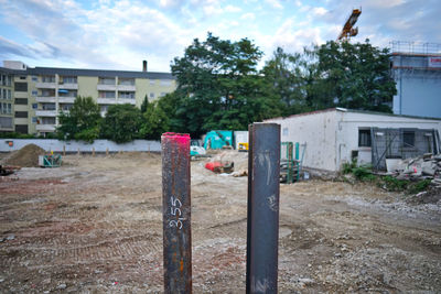 Trees and houses against sky in city