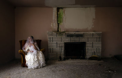 Portrait of woman standing against wall