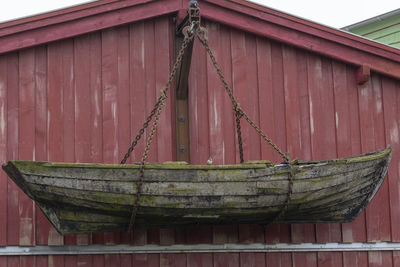 Close-up of rope tied on wooden wall of building