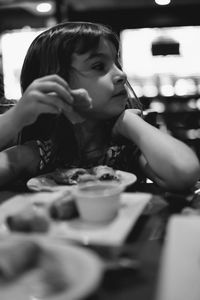 Portrait of woman drinking glass on table