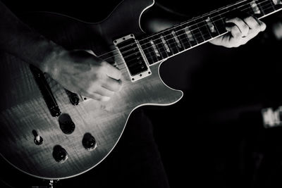 Close-up of man playing guitar