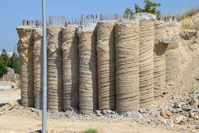 Stack of stones on field against clear sky