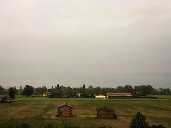 Houses on field against sky