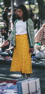 Full length of young woman standing on street