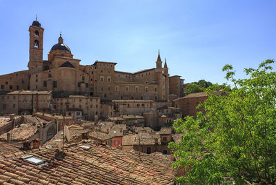 Buildings in town against sky