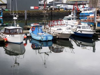 Boats moored at harbor