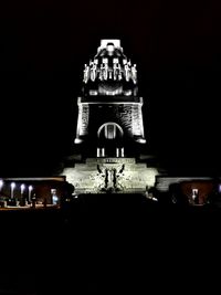 Illuminated building against sky at night