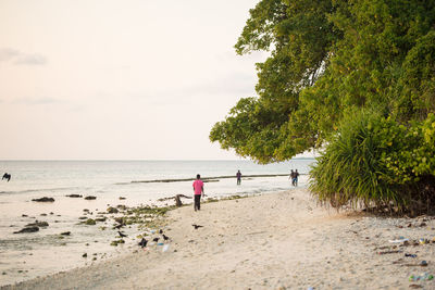 People on beach against sky