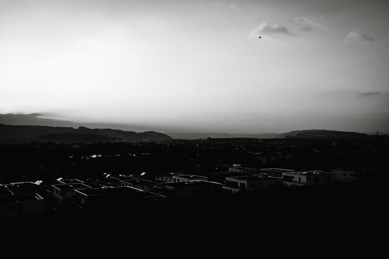 HIGH ANGLE VIEW OF SILHOUETTE BUILDINGS IN CITY