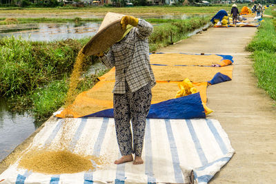 Rear view of people walking by water