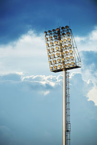 Low angle view of floodlight against blue sky