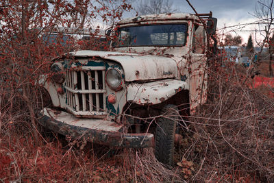 Abandoned car parked on land