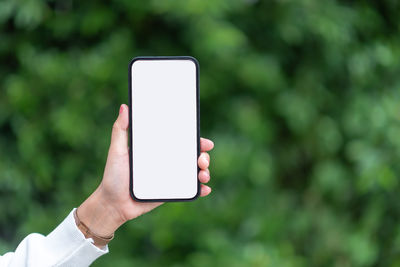 Close-up of hand holding mobile phone