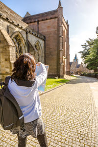 Rear view of woman against built structure