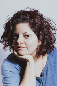 Close-up portrait of beautiful woman against white background