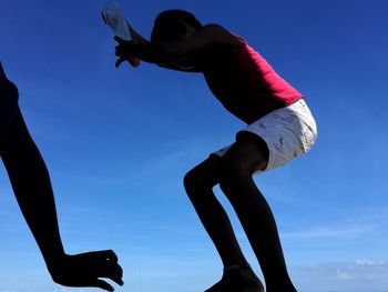 Low angle view of silhouette man against clear sky