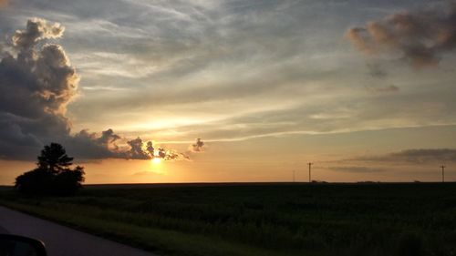 Scenic view of field against sky during sunset