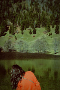 Rear view of woman sitting on field