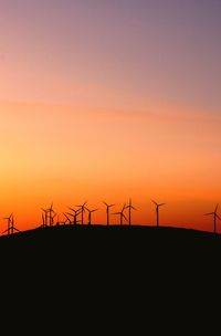 Silhouette of wind turbines at sunset