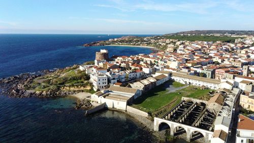 High angle view of townscape by sea against sky