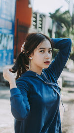 Portrait of young woman standing outdoors