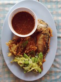 High angle view of fried fish in plate on table