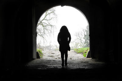 Silhouette of person in tunnel